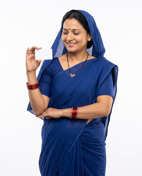 proud indian rural woman looking down at blank white card for successful government loan subsidy approval campaign banner advertising banner