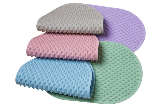 Set of colorful silicone trivet drying mats with pyramid texture isolated on white background