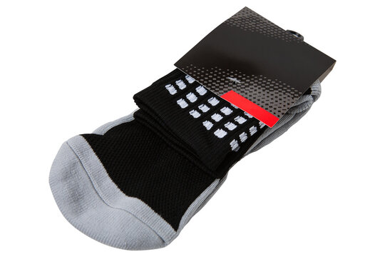 Pair of black and grey athletic socks in paper packaging isolated on white background