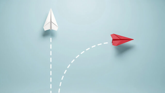 Single red paper airplane deviating from the path of a white paper airplane with paper plane different direction innovation creativity strategy decision leadership transformation deviation