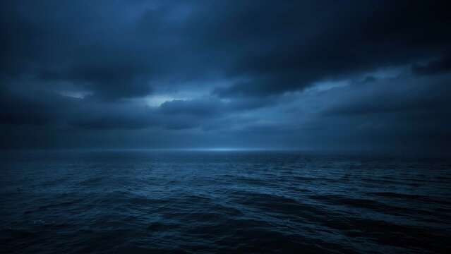 Dark moody ocean seascape under a dramatic cloudy sky at twilight