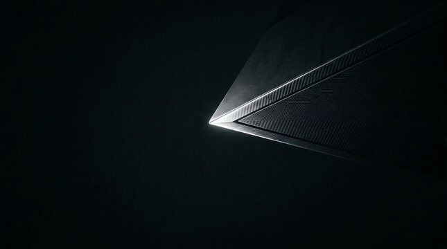 Futuristic geometric triangle with carbon fiber texture glowing in the dark abyss, representing advanced aerospace technology and minimalist design in a high-tech abstract 3D render.