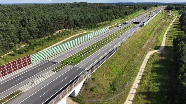 Vehicles and trucks moving on multi lane highway aerial view