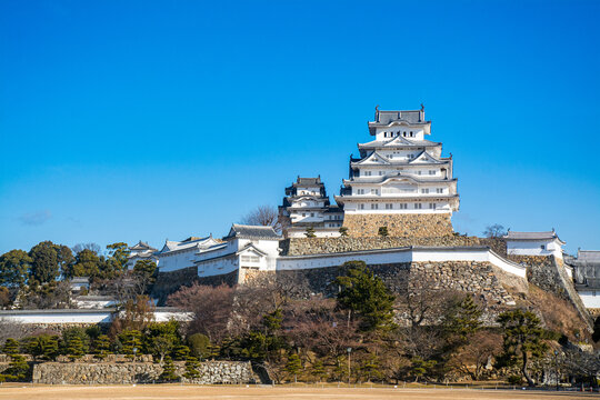 Historic Japanese Himeji castle with white plaster walls and stone fortifications