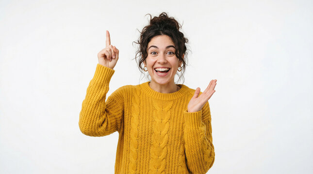 Happy young woman in a yellow sweater pointing a finger upwards with a great idea perfect for illustrating bright concepts inspiration and joyful realization