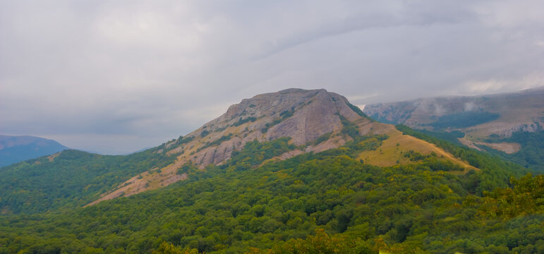 autumn mountain ridge under a blue cloudy sky, outdoor mountain travel scene
