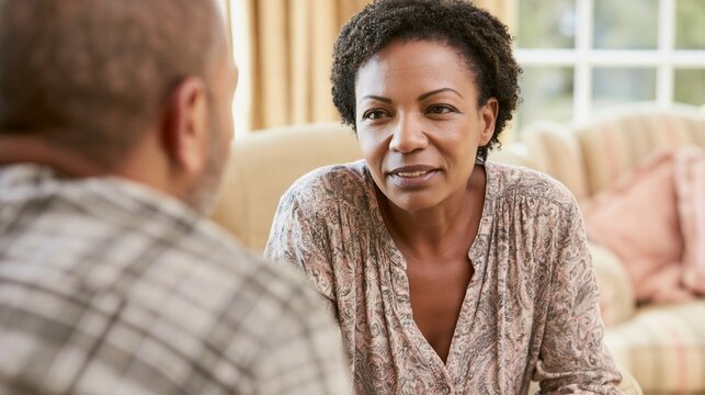 Female Psychologist Listening to Male Patient During Mental Health Therapy Session