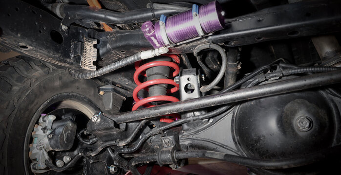 Car suspension and drive shaft. Structure of EV car spare parts. Such as Front or Rear suspension Shock absorber suspension Brake. Elements of the suspension and Chassis structure. Car service repair.