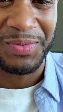 A happy young Black man smiles and speaks directly, displaying positive emotions and engaged communication. His friendly expression conveys genuine connection and a joyful mood. Ideal for happiness.