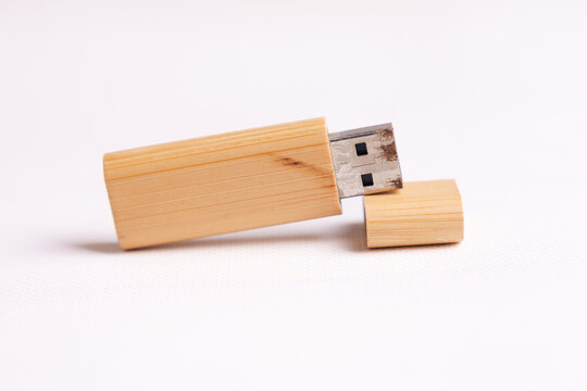 An aged bamboo USB flash drive with a visibly rusted USB connector, illustrating product longevity, aging technology, wear and tear, and continued functionality after years of use