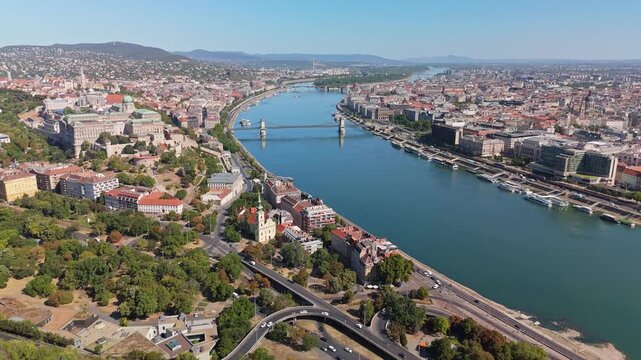 Budapest, Hungary cityscape with the Danube, Sz&eacute;chenyi Chain Bridge, Parliament and Buda Castle in the downtown skyline, with roads, trams and boats seen from a drone.