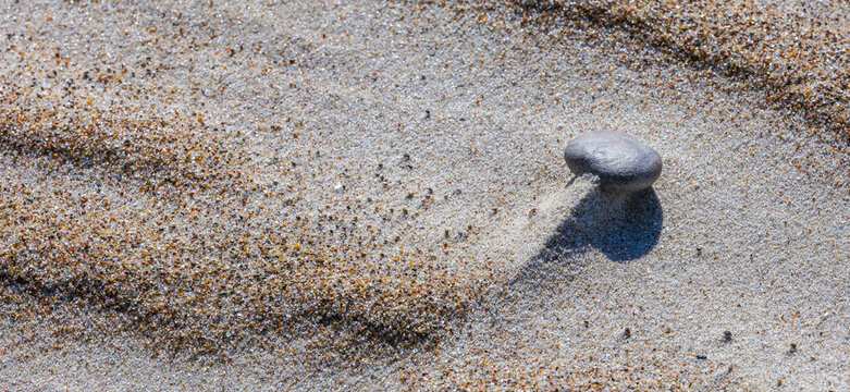 Close-up abstract of perfect wind ripple patterns in white sand dunes forming gentle waves