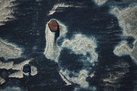 Close-up abstract of perfect wind ripple patterns in white sand dunes forming gentle waves