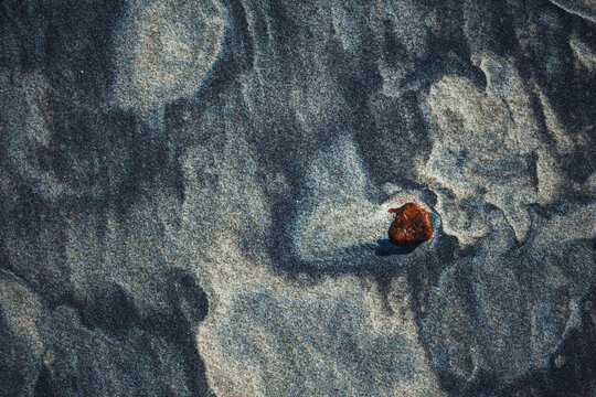 Close-up abstract of perfect wind ripple patterns in white sand dunes forming gentle waves