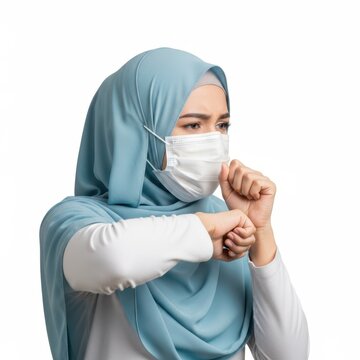 Woman wearing hijab and mask making fist