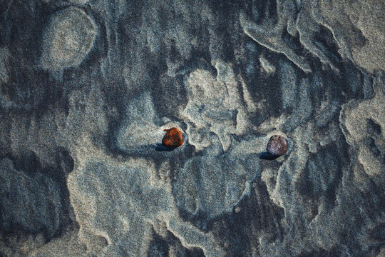 Close-up abstract of perfect wind ripple patterns in white sand dunes forming gentle waves