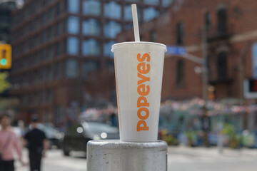 Obraz premium discarded Popeyes Louisiana Kitchen beverage cup on Queen St W, Toronto (front)