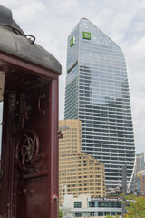 Obraz premium historic passenger wagon at Roundhouse Park and a distant view of Metro Toronto Convention Centre, Intercontinental hotel, and TD Terrace