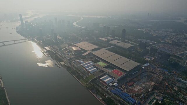Aerial View of Large Convention Center Complex by River in Hazy City