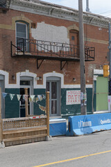 Fototapeta premium historic commercial building located at 458-460 Queen St W (former Duke of Connaught Tavern, now Drom Taberna), Toronto - patio on Augusta Av