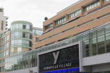 Fototapeta premium exterior building facade and sign of Yorkville Village, an upscale shopping centre in Toronto’s Bloor–Yorkville neighbourhood, located at 55 Avenue Rd