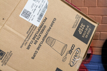 Obraz premium discarded cardboard box that once held Dart Conex ClearPro clear plastic cold-drink cups made by Dart Container in Toronto