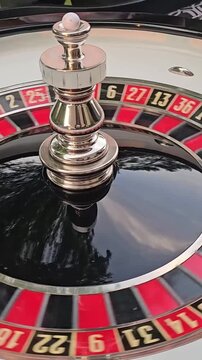 Roulette wheel spins in casino during evening gaming session