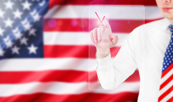 Man in a patriotic necktie checks a virtual ballot before an American flag