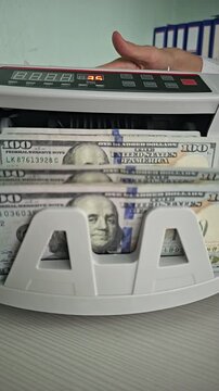 Counterfeit detection using a money counting machine in a business setting