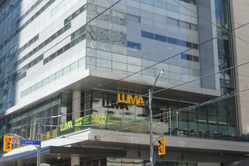 Obraz premium exterior building facade corner detail with marquee sign and Luma, a restaurant, located at 350 King St W, 2nd Floor, TIFF Lightbox / Reitman Square condo complex, Toronto