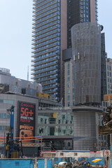 Obraz premium wall mounted billboard with Rogers Communications promotion of 5G+ and iPhone at 33 Dundas St E, Toronto (near southeast corner of Sankofa Square)