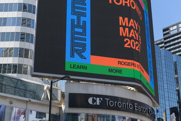 Obraz premium concert promotion for Harry Styles: Together, Together, featuring Lainey Wilson displayed on a digital spectacular at Sankofa Square, Toronto