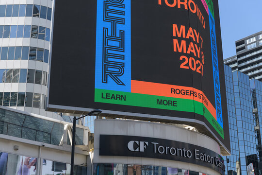 concert promotion for Harry Styles: Together, Together, featuring Lainey Wilson displayed on a digital spectacular at Sankofa Square, Toronto