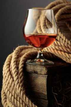 Glass of whiskey on a rough wooden crate.