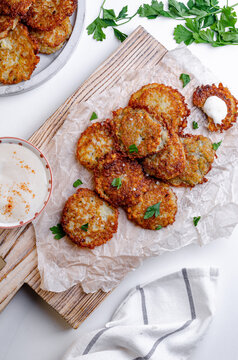 Crispy Potato Pancakes with Sauce on a Wooden Board