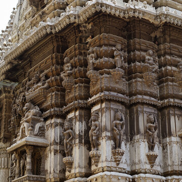 Dancing women (devadasi) and guards intricate sculptures carved on the walls of temple located on the Manikarnika ghat of Varanasi in India.