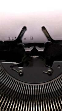 Vertical Macro Shot of Vintage Typewriter Typing the Words It's a Boy