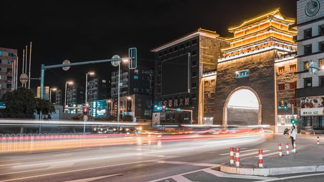 Illuminated Traditional Chinese Gate and Modern City Street at Night in Shenyang, China