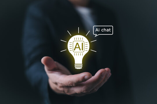 Businessman holding a glowing lightbulb with AI chip and chat bubble icon on hand, representing artificial intelligence technology, smart chatbot innovation, and creative digital idea solutions.