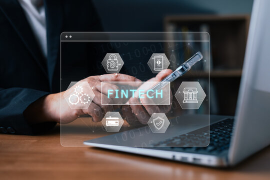 Businessman using smartphone with fintech virtual screen icons, representing financial technology innovation, mobile online banking, digital payment transaction, and cyber security protection.