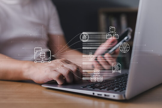 Person using laptop and smartphone with document management system icons on virtual screen, representing cloud storage, online database organizing, cyber security, and digital data processing.