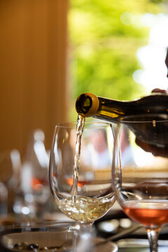 wine getting poured into a glass in a bistro