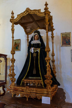 Polychrome wood statue of Nuestra Senora de los Dolores under a gilded canopy inside Iglesia de Santa Maria de Betancuria. Fuerteventura, Spain.