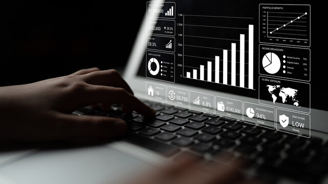 Close-up of hands typing on a laptop showcasing data visualization with graphs and charts, ideal for business analytics and financial performance tracking. Nascent