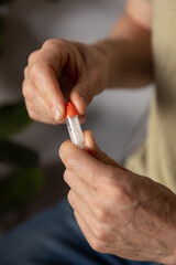 Close-up of hands collecting and preparing a biological sample for genetic analysis at home. The...