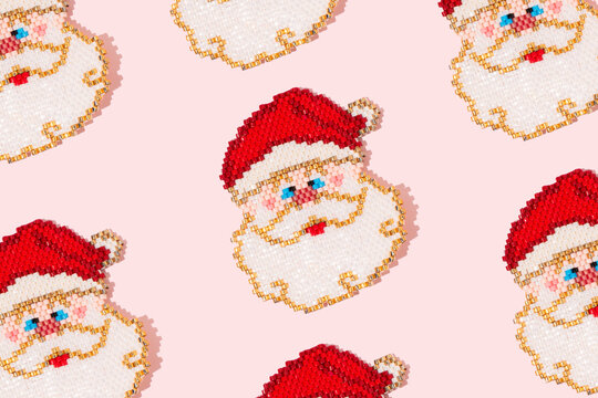 Cute Santa Claus with white beard and red hat on a pink background. Christmas concept.