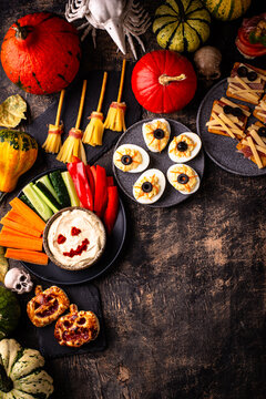 Halloween appetizers with pumpkin hummus deviled eggs and mummy snacks