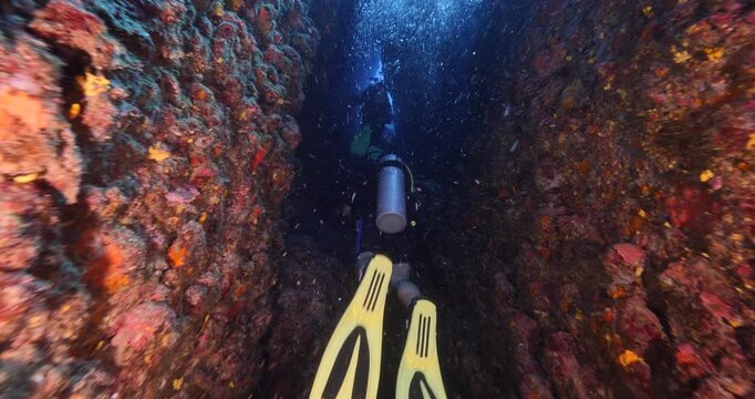 cave diving underwater scuba divers exploring caves and having fun ocean scenery sun beams and rays background