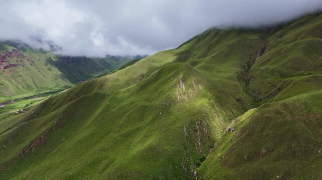 Aerial view of lush green mountain slopes covered by clouds in Cuesta del Obispo, Salta Province, Argentina. Scenic landscape along Route 33 through the Quebrada de Escoipe on the road to Cachi.