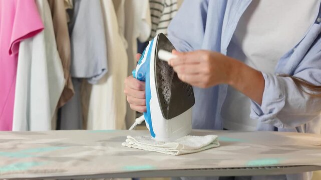Cleaning an iron with a special cleaning pencil to remove burnt residue